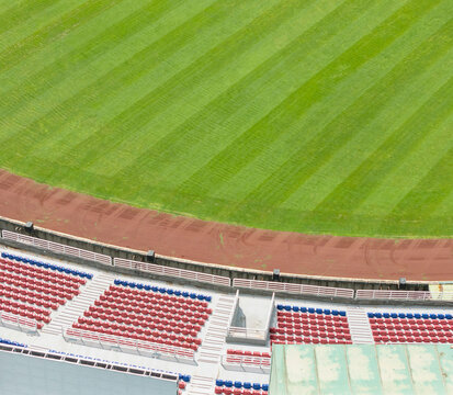 Aerial View of Stadium Seats and Striped Green Field