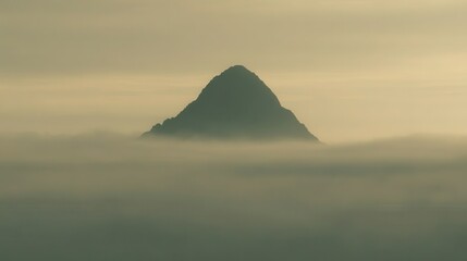 Mountain peak rising above a sea of mist.