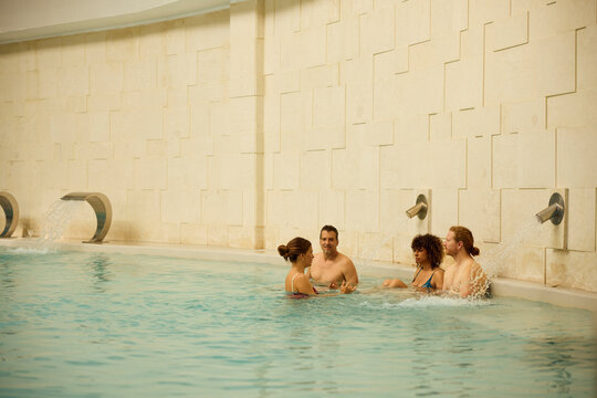 Group of friends enjoy their time in a spa pool