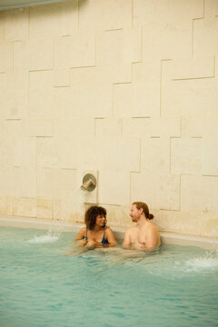 Couple are chatting in the pool