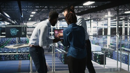 Worried workers trying to fix hacked infrastructure systems. Panicked engineers in data center...