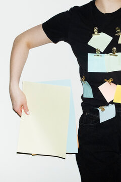 Person having post it notes in the shirt in business office with flash