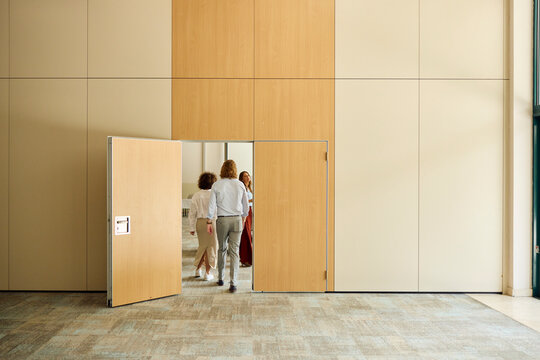 Businesspeople enter the conference room