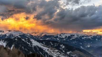 Dramatic sunset over snow-capped mountains.
