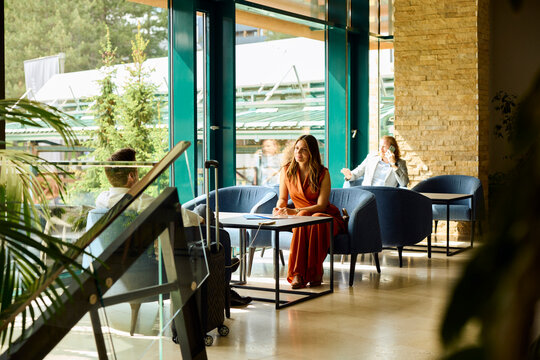 Guests are seated in the hotel lobby