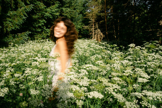 young woman in a field of wild flowers 