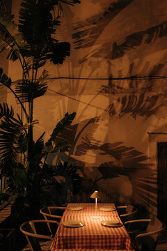 Outdoor dinner table lit by lamp at night in Lisbon