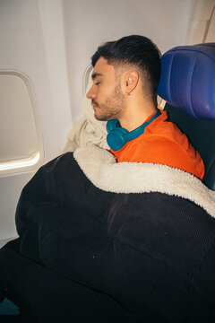 Sleeping Passenger Resting by Airplane Window