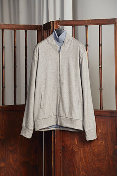 Stylish gray jacket displayed on hanger indoors