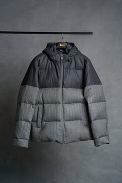 Stylish puffer jacket displayed on hanger indoors