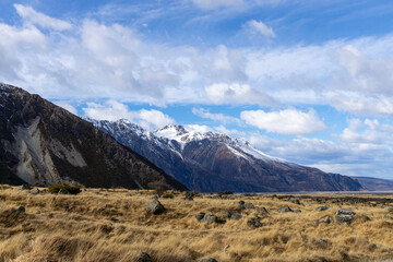 Snow-Capped Mountains Behind Golden Grasslands in Hooker Valley
