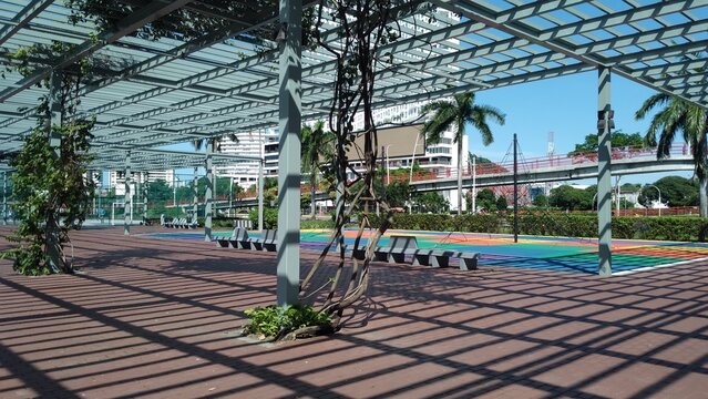 Outdoor park with a metal structure and palm trees in Panama City, summer day