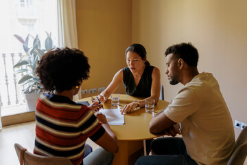Couple meeting with financial advisor and reviewing contract terms