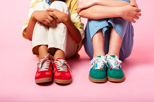Colorful Kids' Sneakers on Pink Background