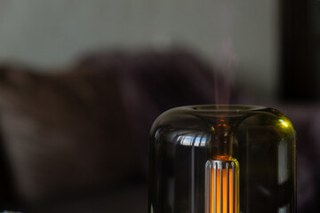 Close up of home perfume scent air humidifier with light. Aromatherapy holistic health practices...