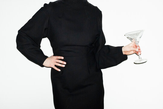 Lady with elegant fashion style backless party dress holding cocktail