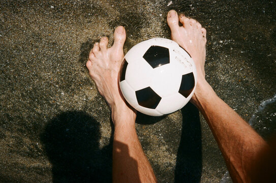Feet and football ball