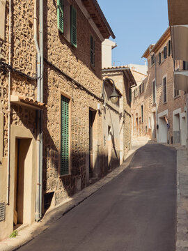 Fototapeta Charming narrow street with rustic architecture