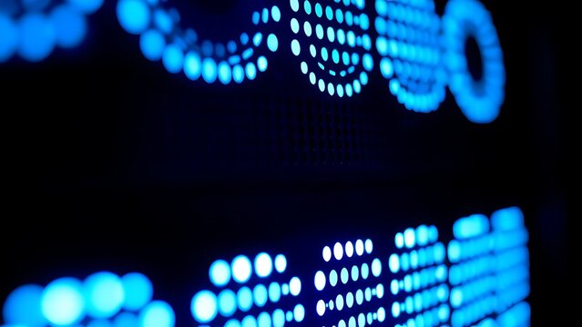 Close-up of glowing blue server rack lights creating an abstract technological pattern on a dark background.