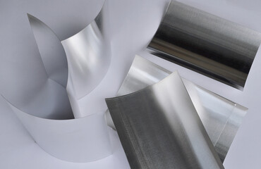 aluminum sheet metal on white surface. curved material
