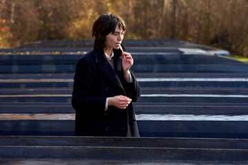Woman reflecting while standing among a landed boats