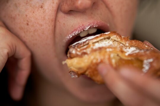 Close-up of Person Enjoying a Pastry During Afternoon Break