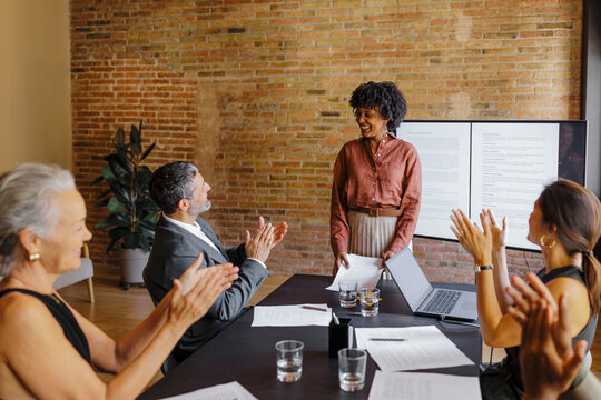 Lawyers clapping hands celebrating successful lawsuit in office