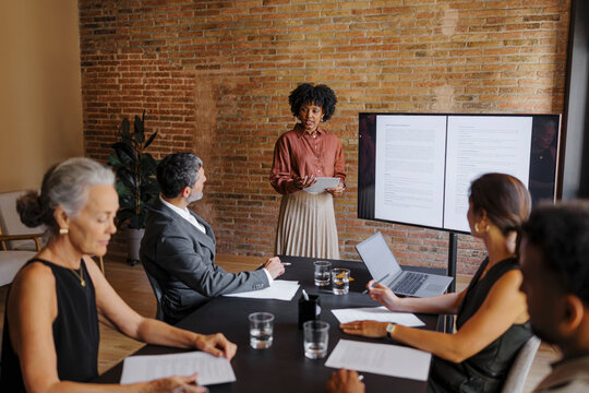 Lawyer giving presentation to colleagues in office meeting room