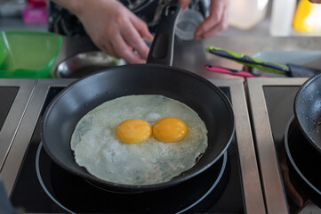 The chef fries the eggs sunny side up. 