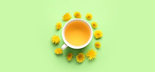 Cup of healthy dandelion tea on color background
