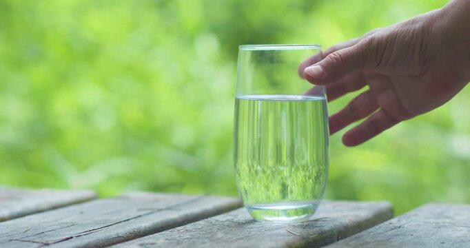 Middle-aged and elderly people reading and drinking water outdoors