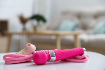 Vibrators with rope on table in living room, closeup