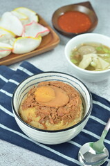 Steamed rice with chicken and egg, served with cracker and chilli,  comfort food for breakfast
