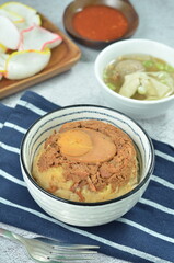 Steamed rice with chicken and egg, served with cracker and chilli,  comfort food for breakfast