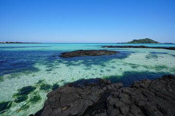 fine view with clear rock beach and far island