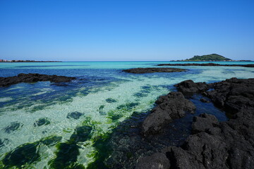 fine view with clear rock beach and far island