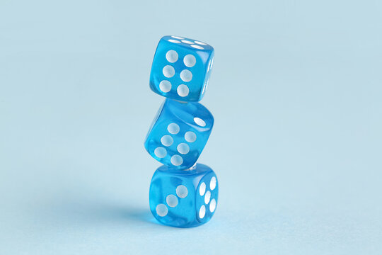 Stack of blue game dices on color background