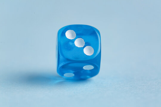 Blue game dice on color background