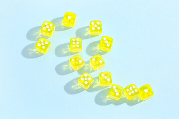 Many yellow game dices on blue background