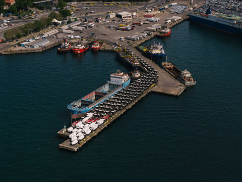 Cargo port with loaded ships and parked vehicles