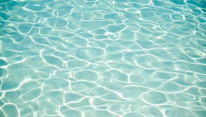 Obraz premium Clear turquoise water surface with sun reflections, a tranquil summer background concept