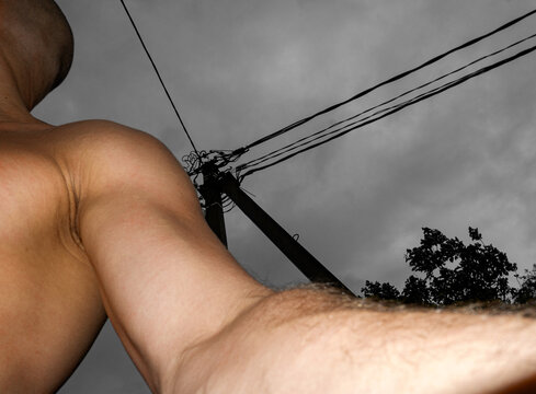 Abstract Body Part Close-up with Dark Power Lines on Cloudy Sky