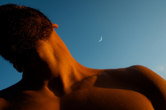 Bare Male Torso and Neck with Crescent Moon at Dusk