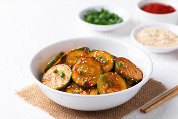 Korean cucumber salad (Oi muchim) in bowl on white background, Korean side dish