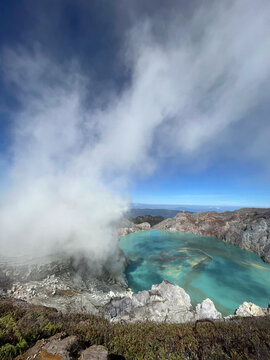 Steaming crater lake with turquoise volcanic water