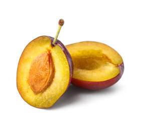 Halves of fresh ripe plum on white background