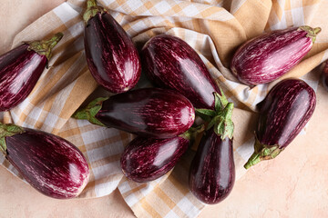 Fresh ripe eggplants on beige background