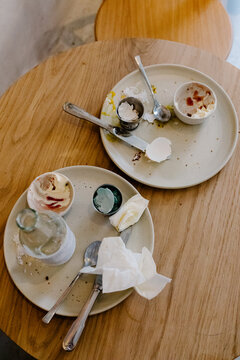 A wooden table with dirty dishes from a traditional Danish breakfast