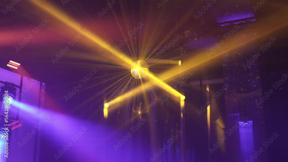 Poster golden light rays shine from a disco ball, creating a radiant glow in a colorful event setting