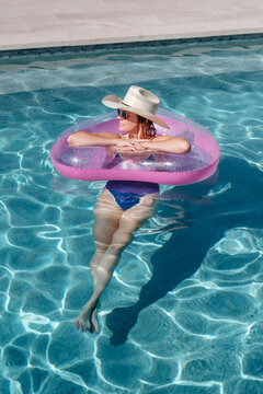 Woman In Cowboy Hat In Pool